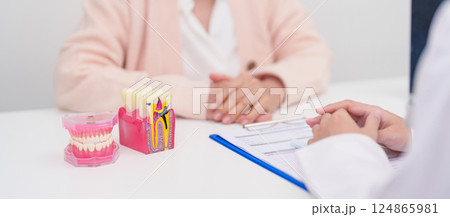 Elderly Patient consulting Dentist to Tooth disease, Senior Health Medical Diagnosis. Anatomy teeth model for Oral Teeth decay, Scrape off tartar. March Oral health, Dentist Day, False Teeth concept Elderly Patient consulting Dentist to Tooth disease, Senior Health Medical Diagnosis. Anatomy teeth model for Oral Teeth decay, Scrape off tartar. March Oral health, Dentist Day, False Teeth concept 124865981