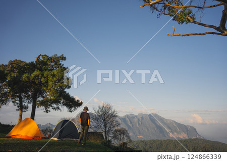 landscape and travel concept with asian man relax see sunset camping tent on mountain landscape and travel concept with asian man relax see sunset camping tent on mountain 124866339