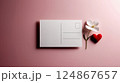 A white postcard with a flower and red heart on pink background 124867657