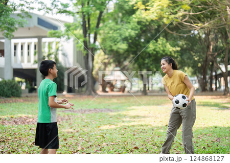 Youth Sports and Joyful Learning. Children engaged in a soccer practice session, promoting physical fitness and teamwork. Youth Sports and Joyful Learning. Children engaged in a soccer practice session, promoting physical fitness and teamwork. 124868127