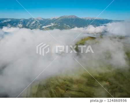 Aerial view of beautiful aura light on foggy  high altitude grassland landscape 124868936