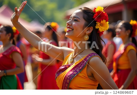 A group of Indonesian women in vibrant traditional attire performing a cultural dance during a festive event. 124869607