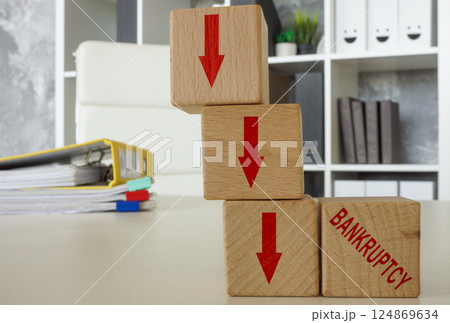 Downward arrows and the word bankruptcy. 124869634