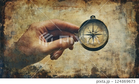Hand holding antique compass on grunge background. (1) 124869673