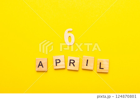 6 April calendar date made by wooden cubes on yellow color background. 6 April calendar date made by wooden cubes on yellow color background. 124870801