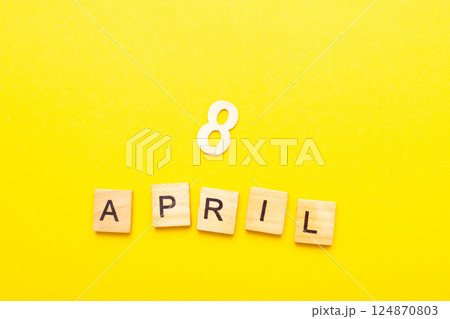 8 April calendar date made by wooden cubes on yellow color background. 8 April calendar date made by wooden cubes on yellow color background. 124870803