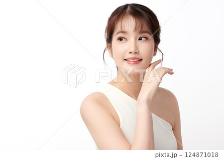 A beautiful young Asian woman with clean, fresh skin against a white background. Skincare, facial treatment, cosmetology, beauty, and spa. An elegant portrait of an Asian woman. A beautiful young Asian woman with clean, fresh skin against a white background. Skincare, facial treatment, cosmetology, beauty, and spa. An elegant portrait of an Asian woman. 124871018