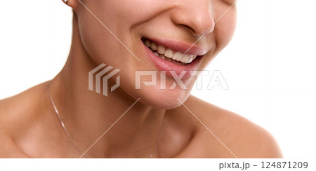 Cropped close-up image of young, smiling, beautiful woman with flawless, spotless skin, plump lips and white teeth. 124871209
