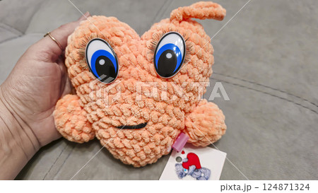 Hand-knitted heart made of plush threads with big eyes. Handmade. Children's toy 124871324