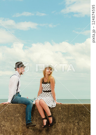Loving couple retro style dating on sea coast Loving couple retro style dating on sea coast 124874595