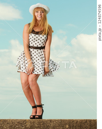 Beautiful retro style girl in polka dotted dress. Beautiful retro style girl in polka dotted dress. 124874596