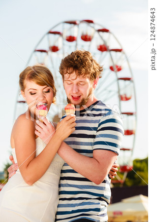 young couple eating ice cream outdoor young couple eating ice cream outdoor 124874643