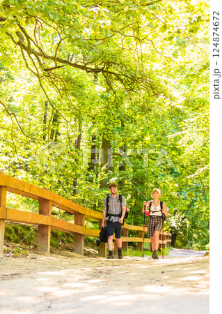 couple backpacker hiking in forest pathway 124874672