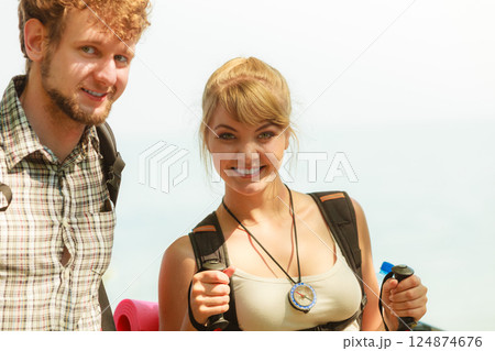 Two people tourists hiking by sea ocean. Two people tourists hiking by sea ocean. 124874676