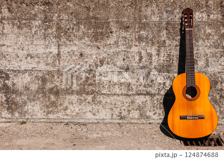 Guitar leaning on wall. 124874688
