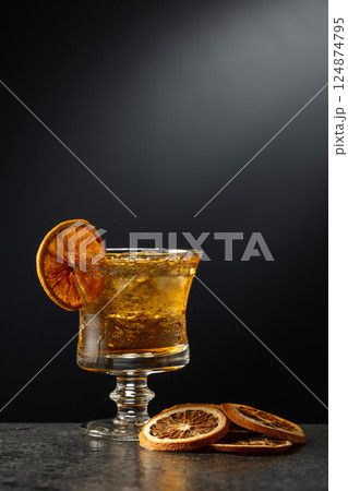 Rum or whiskey in a glass with ice. Rum or whiskey in a glass with ice. 124874795