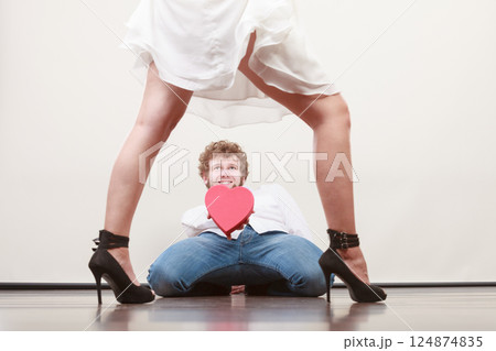 Man with heart shaped gift box for woman. 124874835