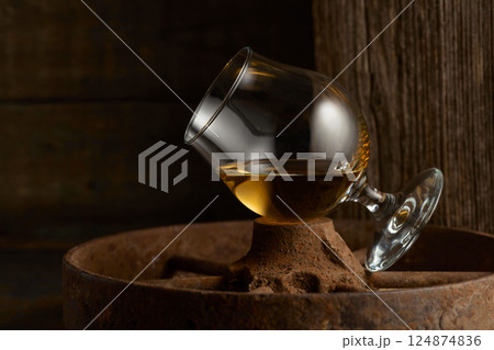 Cognac in snifter on old rusty wheel. 124874836