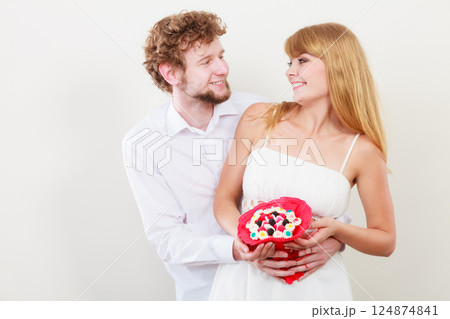 Loving couple with candy bunch flowers. Love. Loving couple with candy bunch flowers. Love. 124874841