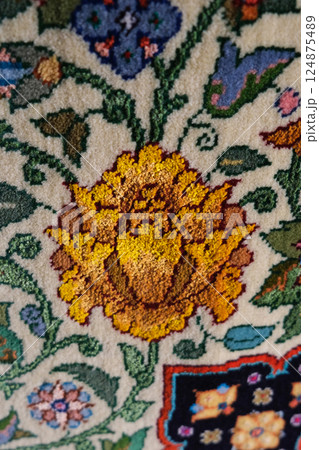 Manufacturing process, weaving of a traditional wool oriental red carpet with an intricate floral pattern, decorative elements Manufacturing process, weaving of a traditional wool oriental red carpet with an intricate floral pattern, decorative elements 124875489