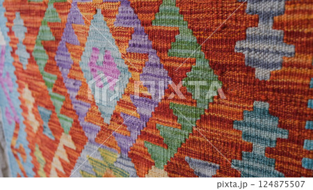 Manufacturing process, weaving of a traditional wool oriental red carpet with an intricate floral pattern, decorative elements Manufacturing process, weaving of a traditional wool oriental red carpet with an intricate floral pattern, decorative elements 124875507