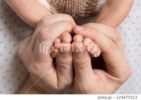 Newborn baby feet. Motherhood concept. Mother day. Copy space. Selective focus 124875521