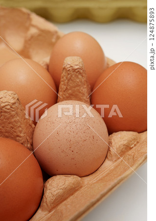 Farm eggs in a beige paper box. Close-up. Farm eggs in a beige paper box. Close-up. 124875893