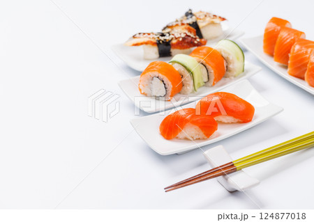 Assorted sushi and maki rolls beautifully arranged on plates 124877018