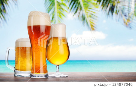An assortment of beer glasses filled with different types of beer An assortment of beer glasses filled with different types of beer 124877046