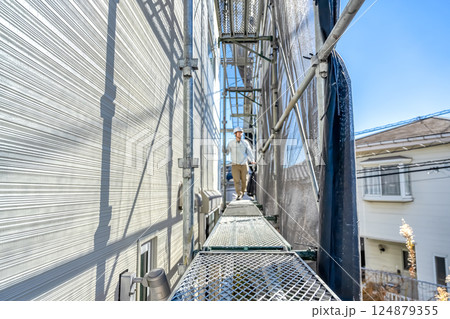 戸建て家屋の外壁修繕工事 作業状況を確認する現場監督 戸建て家屋の外壁修繕工事 作業状況を確認する現場監督 124879355