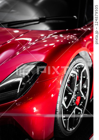 Bold Red Sports Car Front View in Showroom Spotlight, Striking Crimson Performance Vehicle Head-On at Exhibition Display Bold Red Sports Car Front View in Showroom Spotlight, Striking Crimson Performance Vehicle Head-On at Exhibition Display 124879505