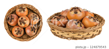 Brown fresh medlars in a wicker basket isolated on white background. Mespilus germanica . Top view. Flat lay 124879543
