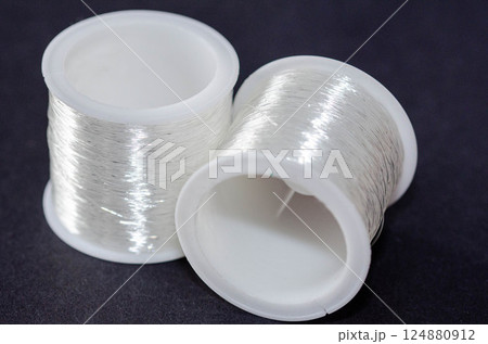 Transparent Nylon Thread on Plastic Spools Closeup 124880912