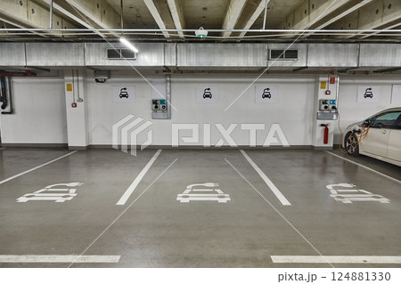 Electric car charging station in a carpark 124881330