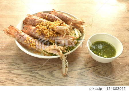 fried mantis shrimp with chop crispy garlic on plate dipping Thai spicy seafood sauce fried mantis shrimp with chop crispy garlic on plate dipping Thai spicy seafood sauce 124882965
