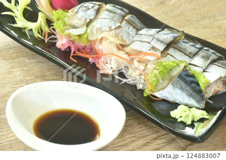 Namizen sashimi or slice saba mackerel fish Japanese food topping chop rasish dressing wasabi and shoyu soy sauce on plate  124883007