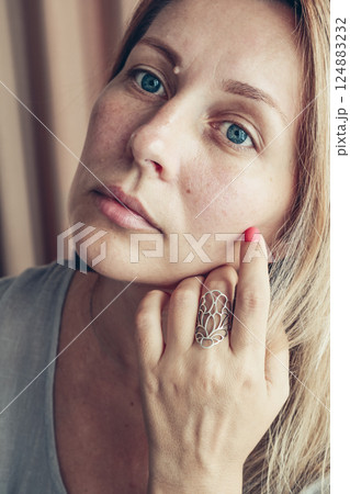 Beautiful mid age woman showing red shellac manicure on nails . Beautiful mid age woman showing red shellac manicure on nails . 124883232