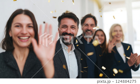 Celebrating Team Success with High Fives and Joyful Smiles in a Bright Office Environment 124884275