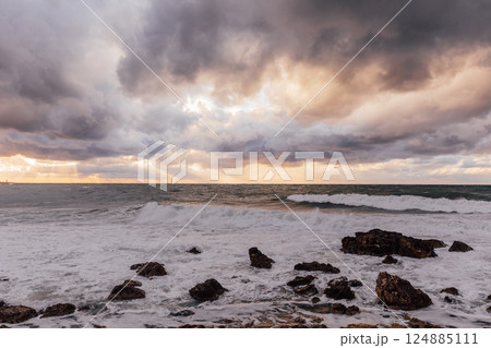 Beautiful landscape, storm on the sea and sunset sky with clouds Beautiful landscape, storm on the sea and sunset sky with clouds 124885111