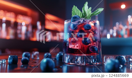 Colorful cocktail with blueberries served at a vibrant bar during night time 124885669