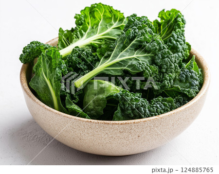 Fresh curly kale leaves in a rustic ceramic bowl Fresh curly kale leaves in a rustic ceramic bowl 124885765