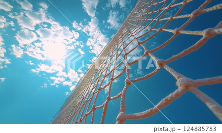 Sky view through a sports net during a sunny day revealing clouds and sunlight 124885783