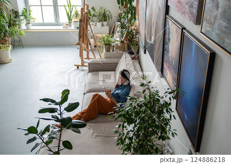 Top view woman artist with smartphone, relaxing checking schedule for art school and work class Top view woman artist with smartphone, relaxing checking schedule for art school and work class 124886218