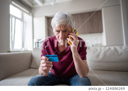 Elderly pensioner trusting scammers sharing card number phone manipulation identity theft fraud 124886269