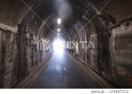 Tunnel with a light shining through it 124887522