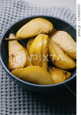 Deliciously Caramelized Pear Slices Served Artfully in a Charming Bowl for Enjoyment Deliciously Caramelized Pear Slices Served Artfully in a Charming Bowl for Enjoyment 124888507