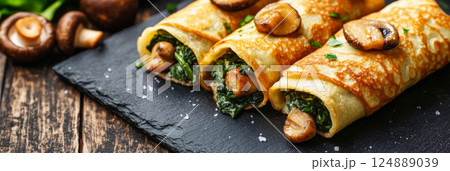 Soft mini crepes stuffed with golden fried mushrooms, fresh spinach, and rich cashew cream. A healthy, dairy-free meal with a perfect blend of crunch and creaminess, banner 124889039