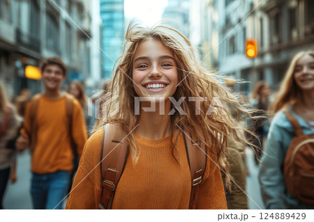 Happy teenagers jumping and enjoying life in a modern city street 124889429