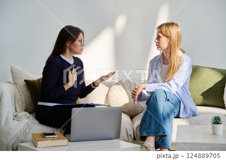 Young woman patient in mental session talking with professional psychologist 124889705
