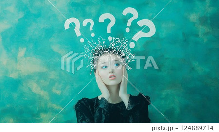 Woman with her hands on her head. There are many questions on the wall behind her. She is looking at the wall 124889714